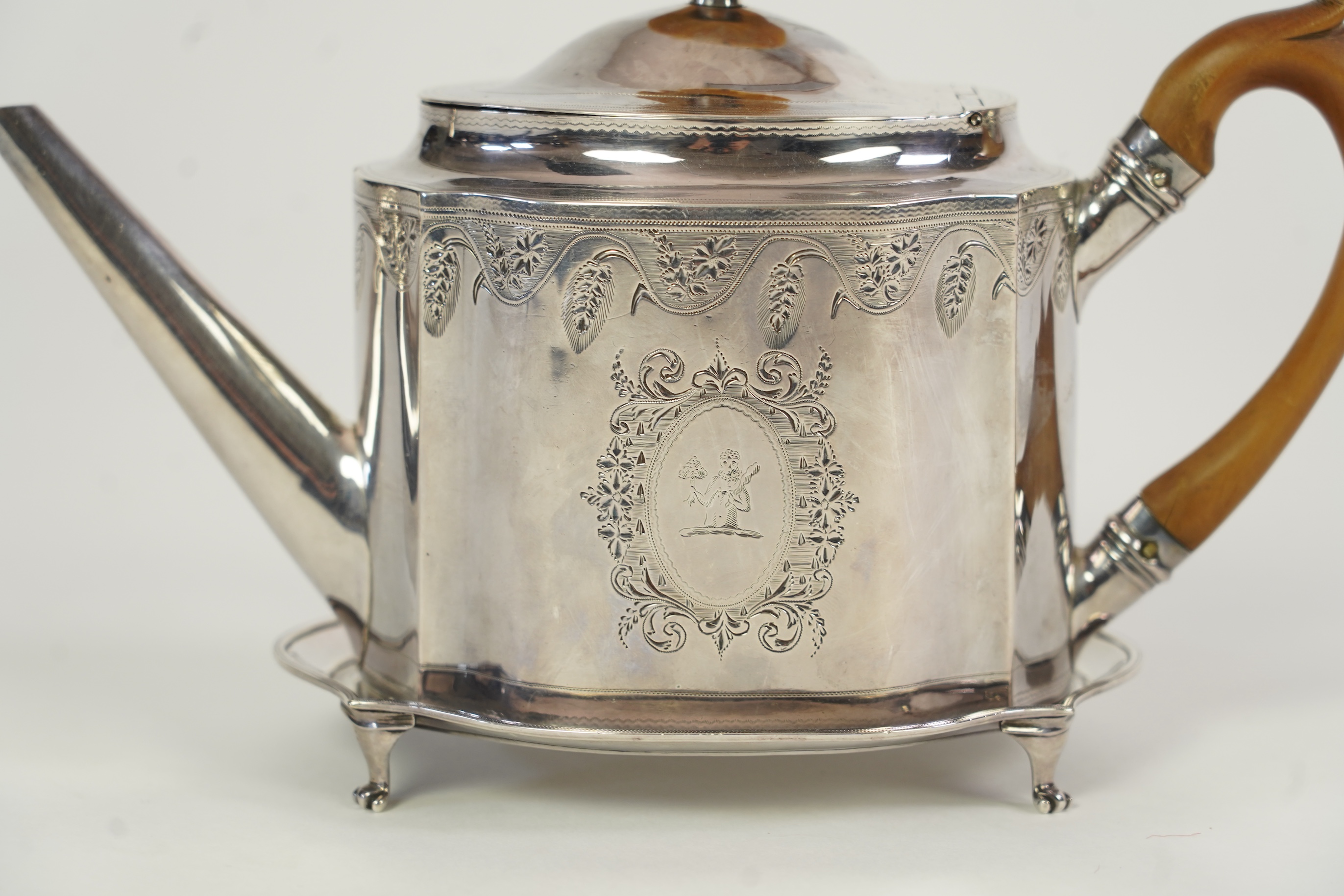 A George III silver teapot and matching stand, by Soloman Hougham